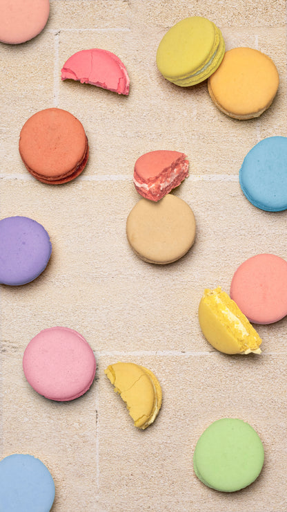 Colorful macarons on a textured surface